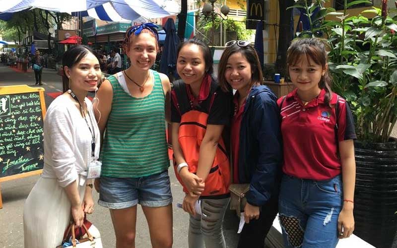 a female English teacher in Cambodia with her students